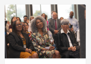 Board of Water and Power Commissioners Cynthia McClain-Hill sitting in the audience, listening to the choir perform.