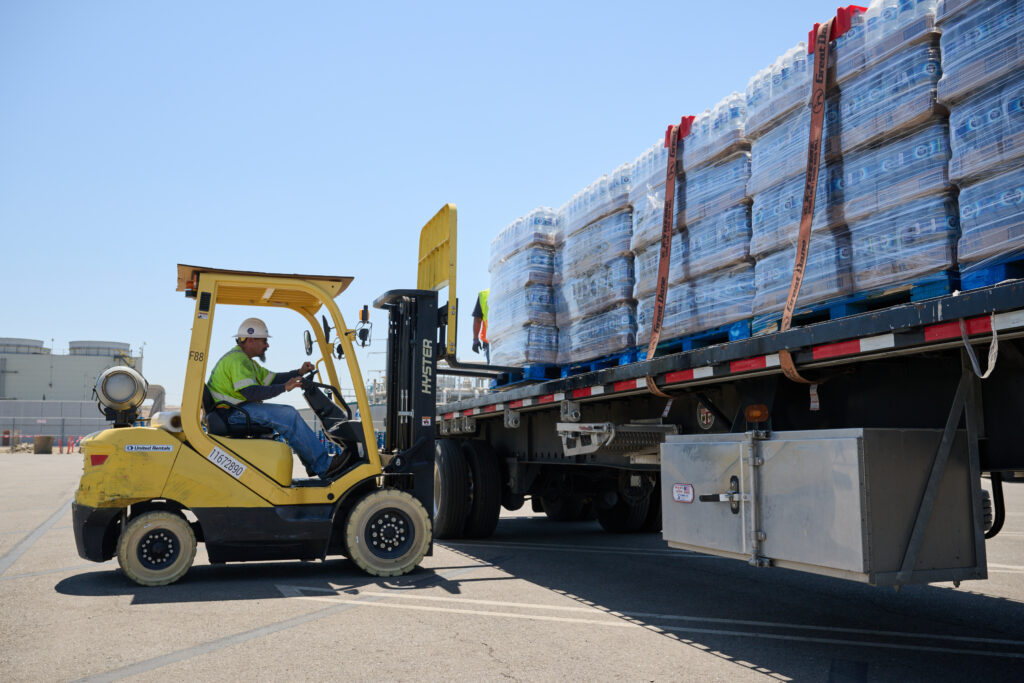 LADWP staff on forklift moving bottled water