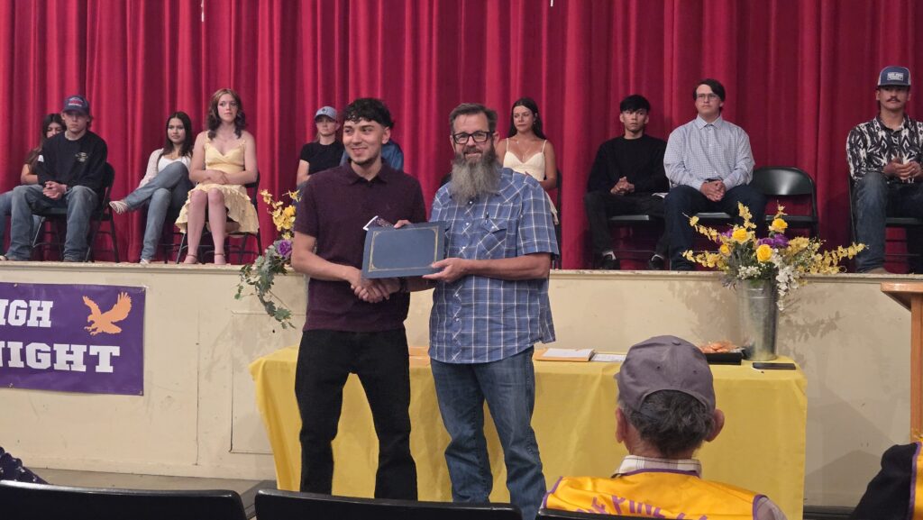 Student is awarded scholarship by LADWP staff.
