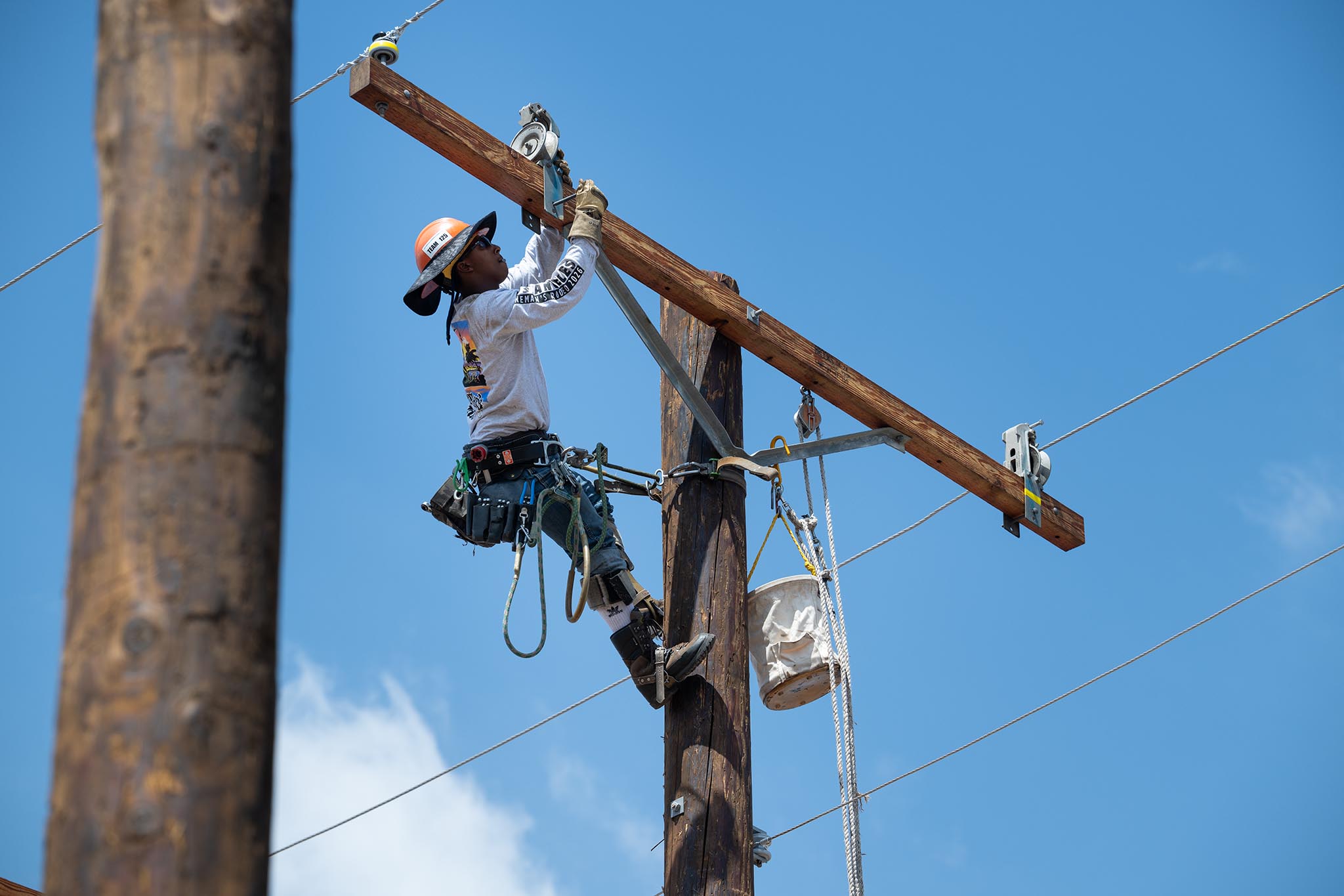 An LADWP lineworker navigates a utility pole while competing in the 2026 Lineman's Rodeo at the LADWP Truesdale Training Center in Sun Valley.