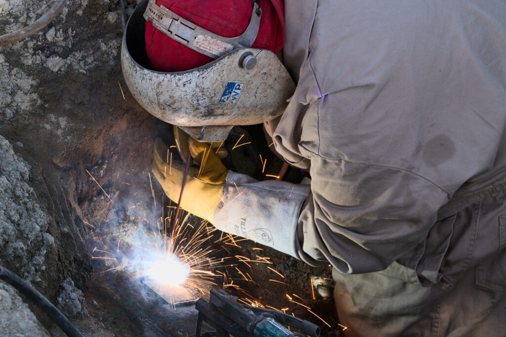 A welder performing work in PPE gear.